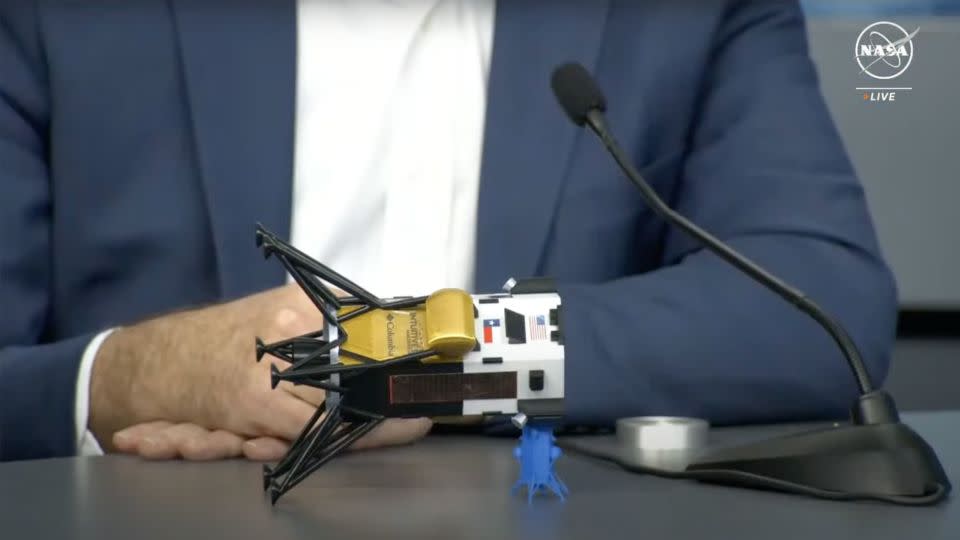 Steve Altemus, chief executive officer and cofounder of Intuitive Machines, uses a model to represent how the Odysseus spacecraft landed on the moon. - NASA