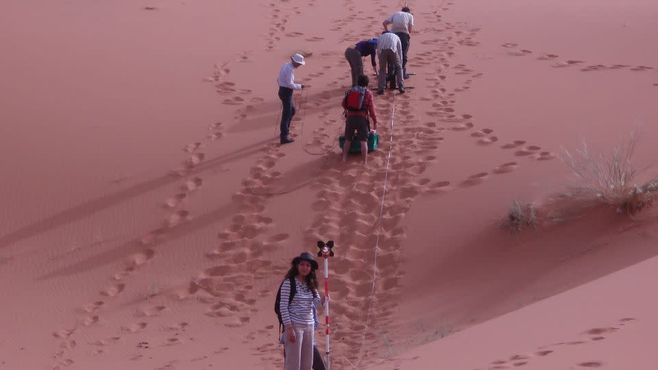 Geology students from the University of London's Birkbeck College survey the star dune at Erg Chebbi. - Charlie Bristow